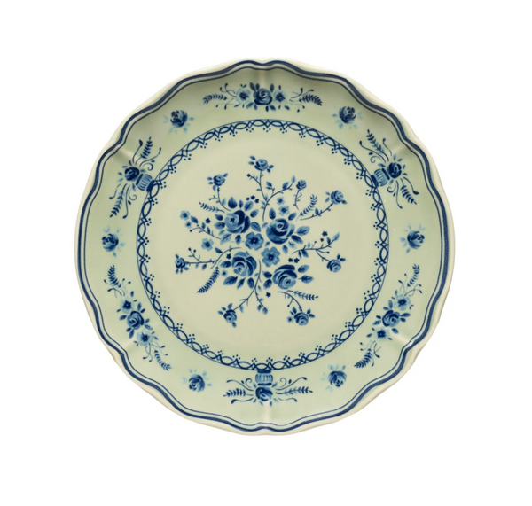 Vila Olive / Blue round plate with a scalloped edge featuring a pale green base and blue floral patterns.