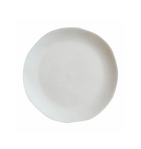 The Maguelone Dinnerware Quartz plate by Jars - Rosenthal features a plain, round, white ceramic design with an organic rim, capturing Mediterranean charm when viewed from above on a white background.