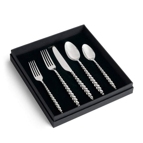 Jessica McCormack Shell Flatware 5 pc Set - Stainless Steel featuring textured, beaded-style handles, presented in a black display box as a luxury designer tableware collection.