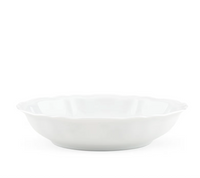 A side view of the Ginori 1735 Antico Doccia Dinnerware white ceramic bowl, featuring a scalloped edge inspired by pure porcelain Antico Doccia designs, set against a plain white background.