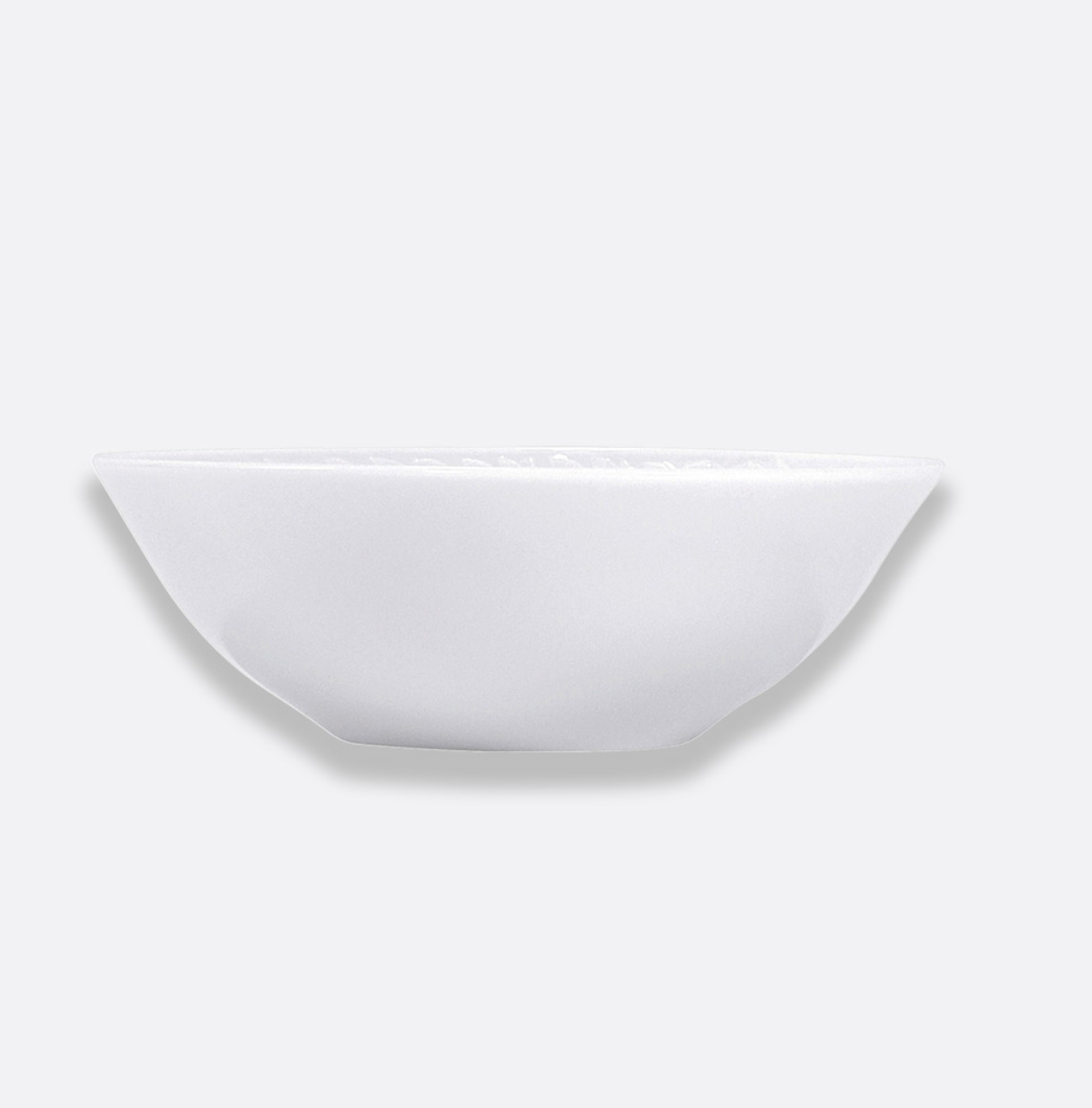 The Louvre Dinnerware shallow round bowl by Bernardaud, crafted from lightweight material and inspired by the timeless elegance of French architecture, is displayed against a light gray background.