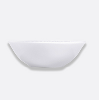 The Louvre Dinnerware shallow round bowl by Bernardaud, crafted from lightweight material and inspired by the timeless elegance of French architecture, is displayed against a light gray background.