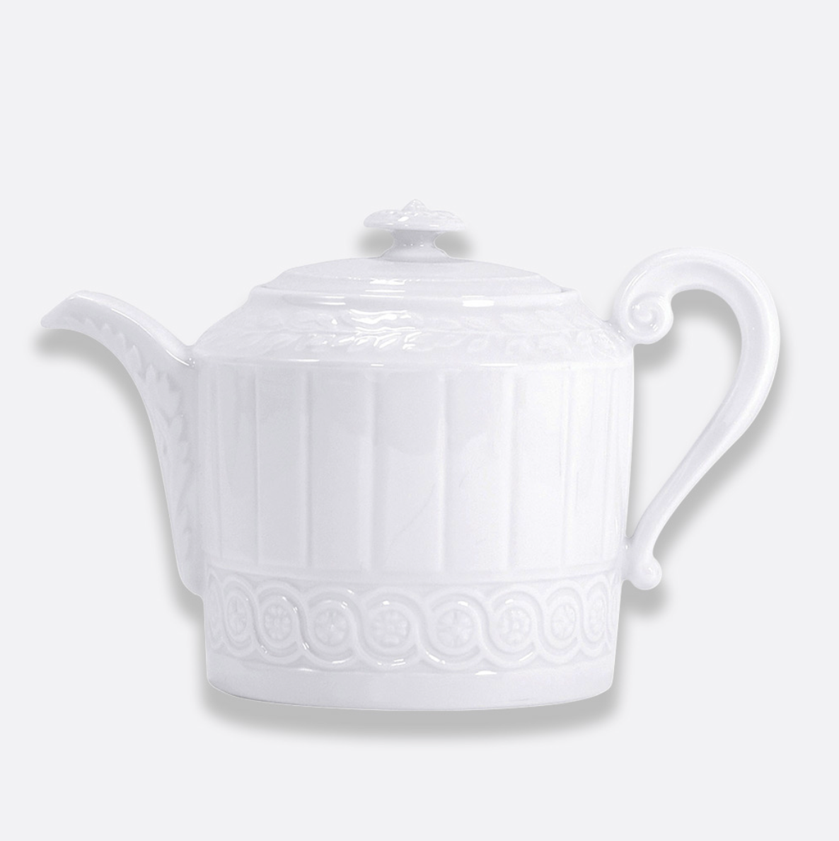 The Bernardaud Louvre Dinnerware collection features a white ceramic teapot adorned with a decorative pattern inspired by Renaissance motifs, complete with a curved handle, short spout, and a lid topped with a small knob—all set against a plain light background—making it an ideal choice for adding elegance to any white table setting.