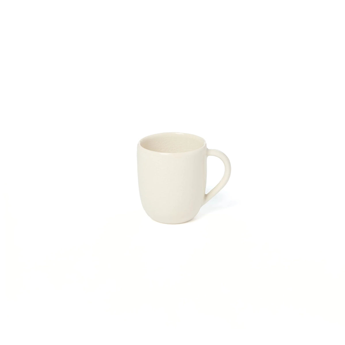 The Maguelone Dinnerware Quartz mug by Jars - Rosenthal, with its plain off-white ceramic and classic handle, exudes the timeless elegance characteristic of Mediterranean-inspired design.
