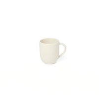 The Maguelone Dinnerware Quartz mug by Jars - Rosenthal, with its plain off-white ceramic and classic handle, exudes the timeless elegance characteristic of Mediterranean-inspired design.