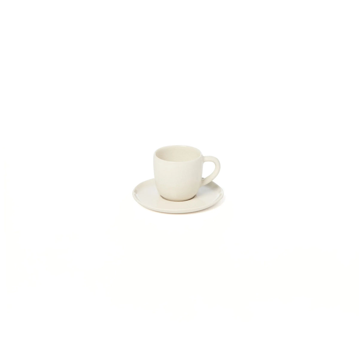 A small, plain white Maguelone Dinnerware Quartz cup by Jars - Rosenthal sits on a matching saucer against a white background, evoking the timeless style of classic Mediterranean dinnerware.