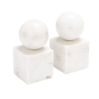 Two white marble sculptures from Designs by Marble Crafter, the Apollo Marble Ball Bookends - Pearl White, feature spherical tops evocative of the iconic Apollo Ball. Gracefully perched on cube bases, these elegant bookends showcase a lustrous pearl white stone finish that stands out against a plain white background, lending an air of refined sophistication to any space.