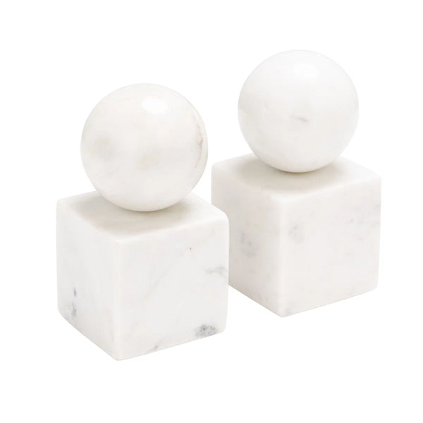 Two white marble sculptures from Designs by Marble Crafter, the Apollo Marble Ball Bookends - Pearl White, feature spherical tops evocative of the iconic Apollo Ball. Gracefully perched on cube bases, these elegant bookends showcase a lustrous pearl white stone finish that stands out against a plain white background, lending an air of refined sophistication to any space.