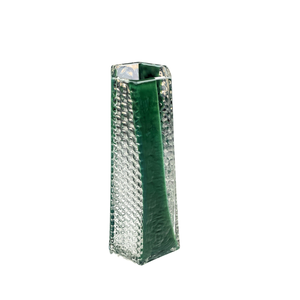 The BB Faceted Mini Vase by Matt Kolbrener is a tall, handblown rectangular glass vase featuring a textured, dimpled surface and a central dark green vertical stripe, offering striking industrial design against a white background.