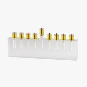 The Apeloig Modern Acrylic Oil Menorah features nine gold candle holders on a clear base. This customizable menorah brings elegance and contemporary style to your Hanukkah celebrations.