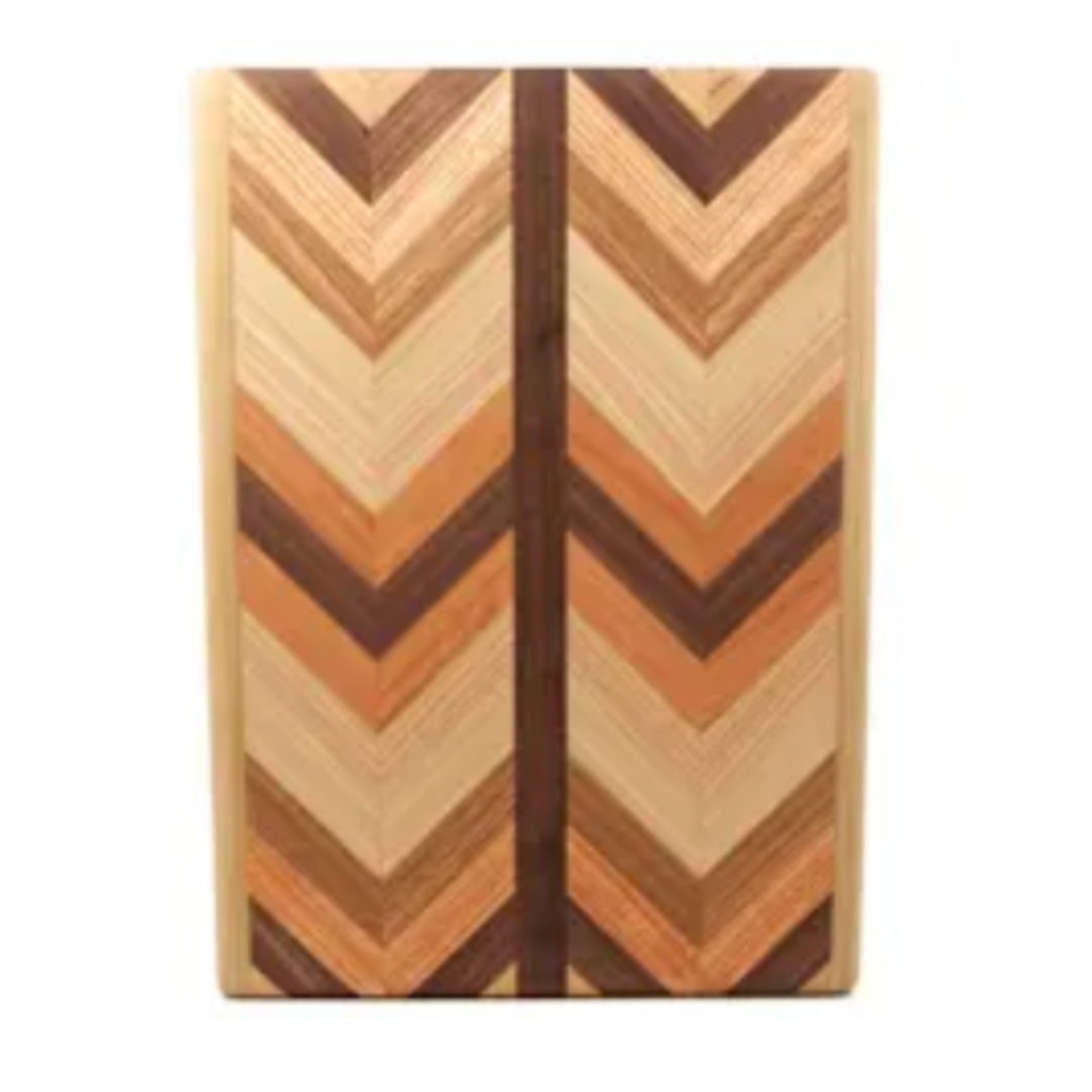 The Multiwood Herringbone Serving Board by Dickinson Woodworking features a rectangular shape with a striking chevron pattern crafted from alternating light and dark wood tones, divided by a central vertical strip.