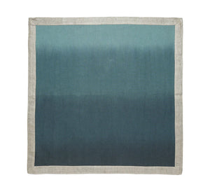 The Kim Seybert Dip Dye Napkins - Cool Tones - Set of 4 features a metallic foil border and gradient blue-to-teal design for an elegant table accent.