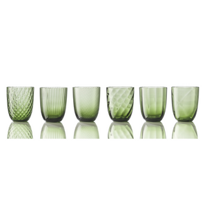 The Idra Mixed Pattern Glass Set of 6 by Nason Moretti features six green cups, each with a distinct textured or patterned surface, displayed side by side on a reflective white surface against a plain white background.