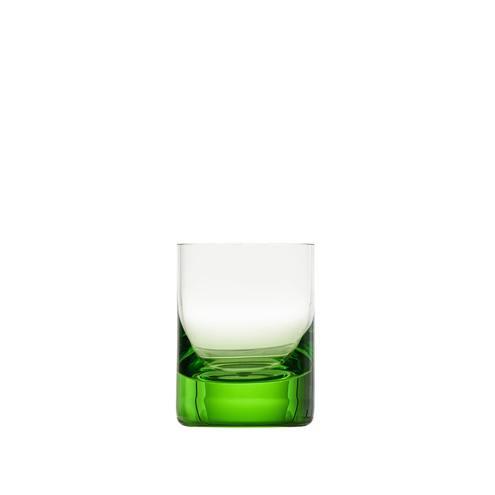 A Whiskey Set Shot Glass by Moser, featuring a clear hand-blown glass design with a thick, solid green base, is elegantly displayed against a plain white background.