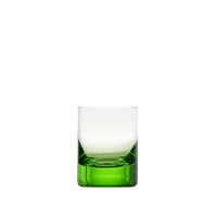 A Whiskey Set Shot Glass by Moser, featuring a clear hand-blown glass design with a thick, solid green base, is elegantly displayed against a plain white background.