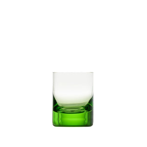 A Whiskey Set Shot Glass by Moser, featuring a clear hand-blown glass design with a thick, solid green base, is elegantly displayed against a plain white background.