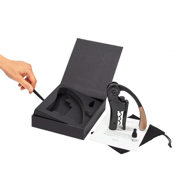 L’ Atelier du Vin Lever Wine Opener - Black with a wooden handle, displayed with its storage box, a small vial, and an instructional pamphlet in this luxury wine gift set.