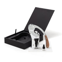 A L’ Atelier du Vin Lever Wine Opener - Silver with wooden handle details, displayed next to its open luxury gift box, a small glass vial, and a white information card.
