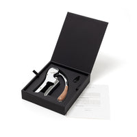 L’ Atelier du Vin Lever Wine Opener - Silver displayed with a wood handle inside an open black luxury gift box, accompanied by a small accessory and a printed note.