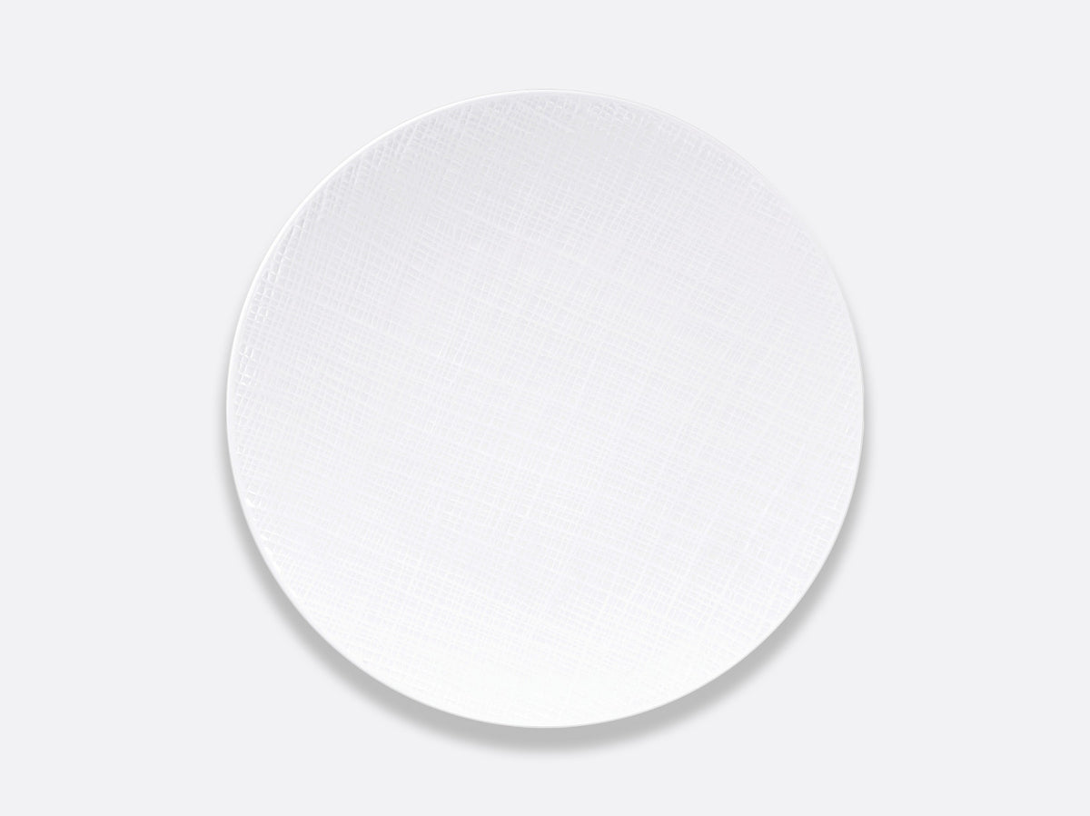 A sleek, round white plate from Bernardaud’s Organza White Dinnerware collection, expertly crafted in fine Limoges porcelain with a delicate textured pattern and set against a light gray background—an ideal choice for modern interior décor.