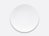 A sleek, round white plate from Bernardaud’s Organza White Dinnerware collection, expertly crafted in fine Limoges porcelain with a delicate textured pattern and set against a light gray background—an ideal choice for modern interior décor.