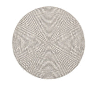 Round, light gray placemats from the Driftwood Placemat Set 4 Grey by Kim Seybert feature pebble-like texture and even design, offering a unique touch to handcrafted table decor or pairing beautifully with a beaded placemat. Seen from above on a white background.