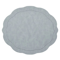 The Kim Seybert Tailored Placemat Set of 4 in Steel Grey features a light steel gray color, wavy edges, a subtle textured pattern, and an oval-shaped embossed border near the center.