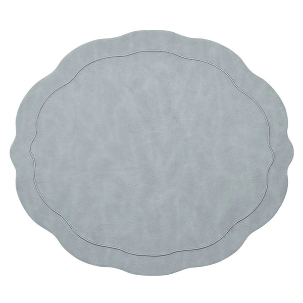 The Kim Seybert Tailored Placemat Set of 4 in Steel Grey features a light steel gray color, wavy edges, a subtle textured pattern, and an oval-shaped embossed border near the center.