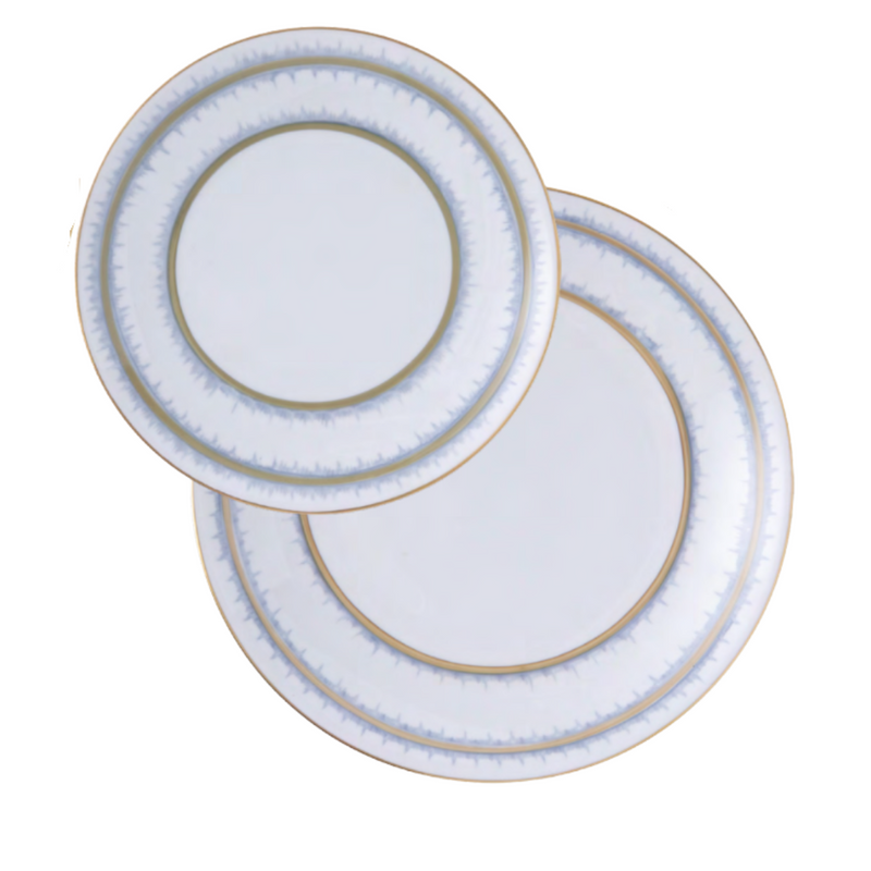 Two Marie Daâge Rafia 5 Dinnerware plates, featuring white porcelain with gold and blue rim details, are stacked on a white background, highlighting the luxurious design from the Marie Daâge collection.