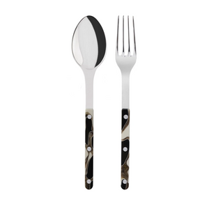 The Sabre Bistro Dune Salad Set includes a metal spoon and fork with polished 18/10 stainless steel tops and handcrafted acrylic handles in a black, white, and brown abstract pattern with silver rivets.