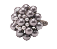 The Deborah Rhodes Jeweled Dome Napkin Ring Set of 4 features a cluster of shiny, round gray pearls in a floral pattern atop a textured silver ring, displayed on a white background.