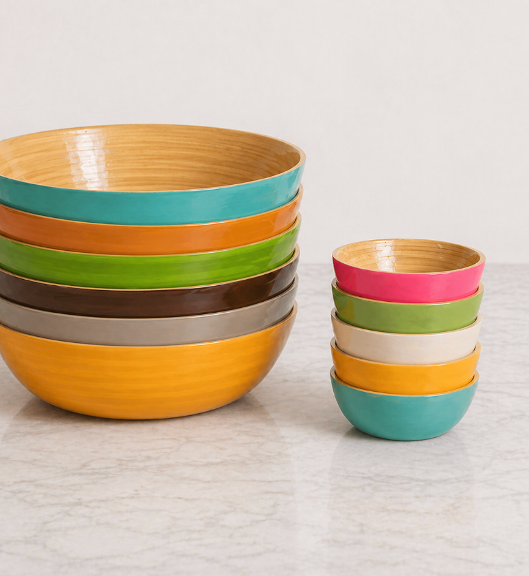 Two stacks of Albert L Bamboo Classic - Mini Dip Bowls with glossy, food-safe finishes sit on a marble countertop. These durable bamboo bowls are perfect for stylish and practical everyday use.
