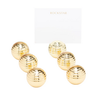 Six gold ribbed Goldie Place Card Holders by Dear Annabelle display a card reading "ROCKSTAR" in gold. Arranged on a plain white background, this set of 6 adds shine and style to any table setting.