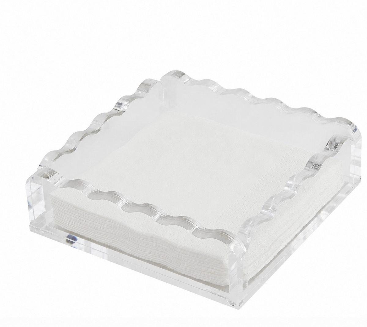 The Tizo Waverly Cocktail Napkin Holder, a clear square acrylic piece with wavy edges, holds white paper napkins and adds a touch of luxury to any setting. Both holder and napkins are displayed against a plain white background.