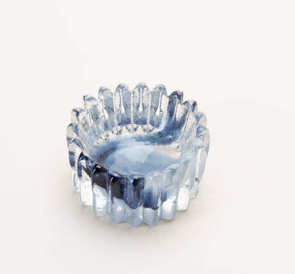 The Splash Catchall Bowl by Gary Bodker is a small, round, translucent handcrafted glass dish with vertical ridges, a wavy edge, and a light blue tint, shown against a plain white background.