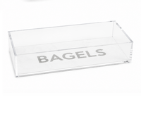 Introducing the Eye Candy Bagel Tray: a clear, rectangular acrylic container featuring the word “BAGELS” in bold gray letters on the bottom. This food-safe tray from Eye Candy makes an ideal gift for any bagel lover.
