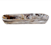 Expertly crafted from shatter-resistant resin, the Swirl Resin Colored Boat Bowl Mocha by Nashi Home showcases a stunning marbled design in white, brown, and gray. This long, shallow oval bowl makes a striking addition to your home décor and displays beautifully against a white background.