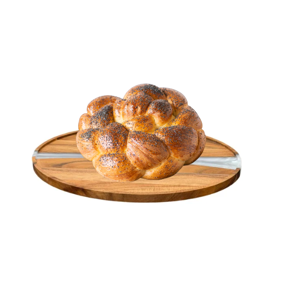 A round braided challah bread topped with poppy seeds sits on the BT-Shalom Resin and Wood Challah Board, ready to be served at the Shabbos table, set against a white background.