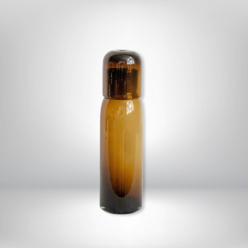 The Volverde Glassware Handblown Glass Carafe Straight - Chocolate stands upright on a light gray background, its matching cap in place and a faint shadow cast beneath it.