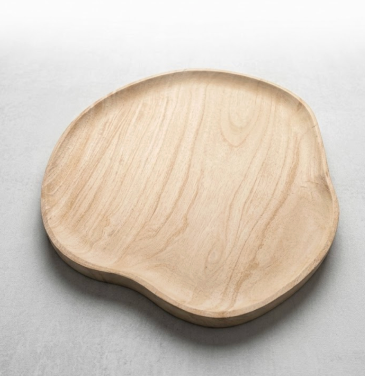 The Ultimate Resin Cheese Board Beige by Current Home features a smooth, organic asymmetrical design and subtle grain patterns. With slightly raised edges, it serves as an elegant centerpiece or stylish serving platter for any table.