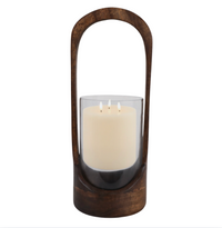 The Modesto Hurricane - Walnut - by Sagebrook Home features a white three-wick candle in a glass holder inside a dark walnut lantern with a tall curved handle, ideal for modern home decor against a plain white background.