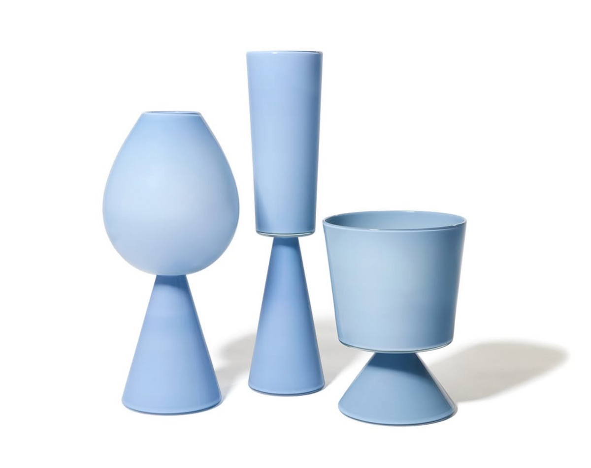 The Cariati Fiorelli Collection Vase - Dove features modern, pastel blue ceramic with a conical base and smooth finish, evoking sculptural glass elegance against a white background.