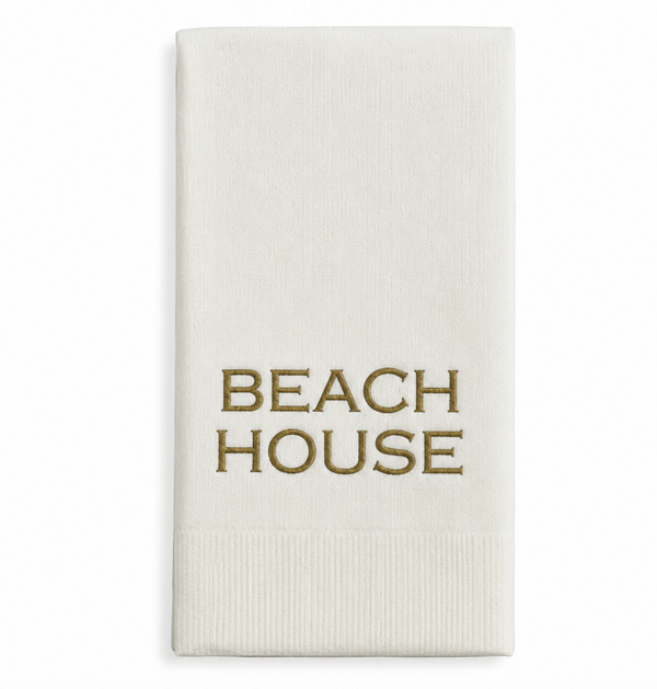 White towel with 'BEACH HOUSE' text in gold on a white background