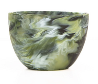 The Nashi Home Swirl Colored Resin Deep Bowl features a hand-crafted marbled green, white, and black pattern and is photographed against a white background.
