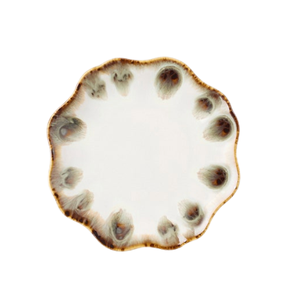 The Amoria Dinnerware by Blue Pheasant features a round ceramic plate with a wavy, scalloped edge, showcasing a white center complemented by a brown and gray reactive glaze pattern along the rim for vintage-inspired elegance.