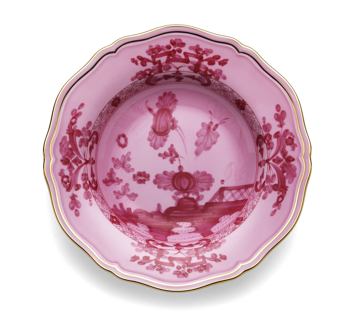 A pink porcelain bowl from the Oriente Italiano Porpora collection by Ginori 1735, featuring scalloped edges, gold trim, and intricate red floral and decorative patterns inspired by elegant chinoiserie motifs.
