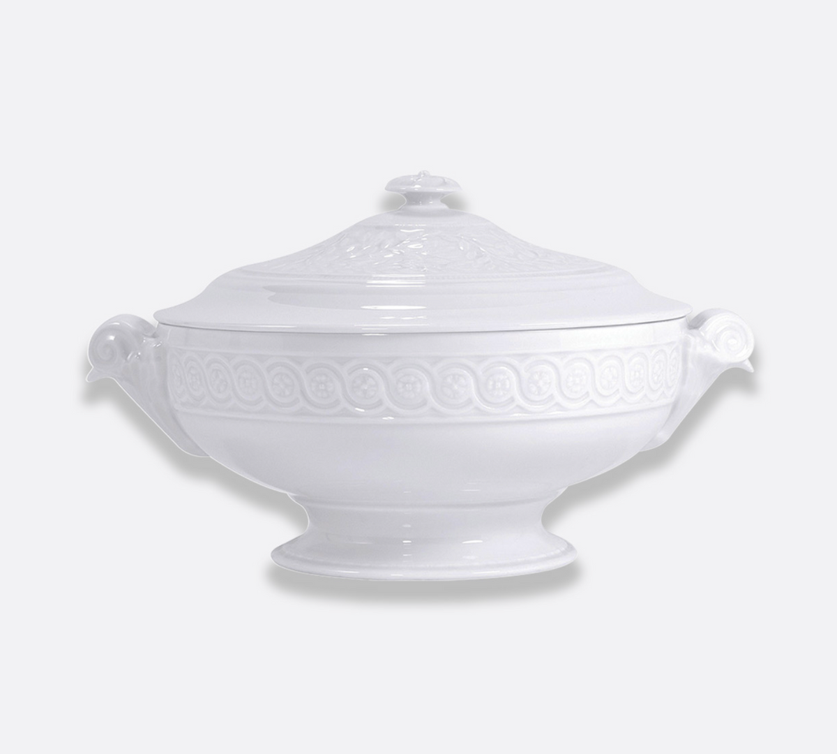 The Bernardaud Louvre Dinnerware porcelain tureen features decorative handles and an ornate matching lid, with an embossed rim and base inspired by Renaissance French architecture, displayed against a plain light background—an elegant addition to any white service.