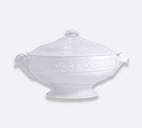 The Bernardaud Louvre Dinnerware porcelain tureen features decorative handles and an ornate matching lid, with an embossed rim and base inspired by Renaissance French architecture, displayed against a plain light background—an elegant addition to any white service.