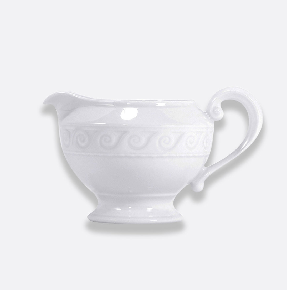 The Bernardaud Louvre Dinnerware gravy boat, crafted from white ceramic with a curved handle and embossed swirl pattern inspired by Renaissance elegance, is set against a plain light background—an ideal accent for your white service.