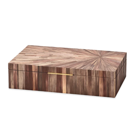 The Palm Marquet Box - Brown by Jamie Young is a rectangular wooden box featuring a striking starburst pattern on the lid and a sleek gold handle on the front. Its richly grained wood showcases varying shades of brown, capturing an organic tropical aesthetic inspired by classic mid-century design.